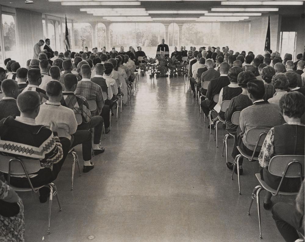 1960's people listening to speaker